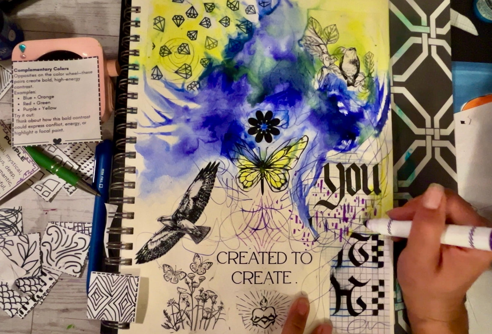Artistic notebook with butterfly design and text on a textured surface